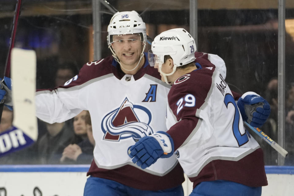 Colorado Avalanche center Nathan MacKinnon (29) celebrates after scoring against the New York Rangers with right wing Mikko Rantanen during the first period of an NHL hockey game, Monday, Feb. 5, 2024, at Madison Square Garden in New York. (AP Photo/Mary Altaffer)