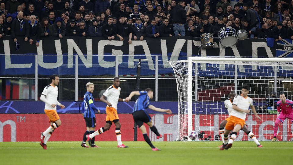 FILE - In this Wednesday, Feb. 19, 2020 file photo, spectators sit in the stands during the Champions League round of 16, first leg, soccer match between Atalanta and Valencia at the San Siro stadium in Milan, Italy. It was the biggest soccer game in Atalanta’s history and a third of Bergamo’s population made the short trip to Milan’s famed San Siro Stadium to witness it. Nearly 2,500 fans of visiting Spanish club Valencia also traveled to the Champions League match. More than a month later, experts are pointing to the Feb. 19 game as one of the biggest reasons why Bergamo has become one of the epicenters of the coronavirus pandemic — a “biological bomb” was the way one respiratory specialist put it — and why 35% of Valencia’s team became infected. The new coronavirus causes mild or moderate symptoms for most people, but for some, especially older adults and people with existing health problems, it can cause more severe illness or death. (AP Photo/antonio Calanni, File)