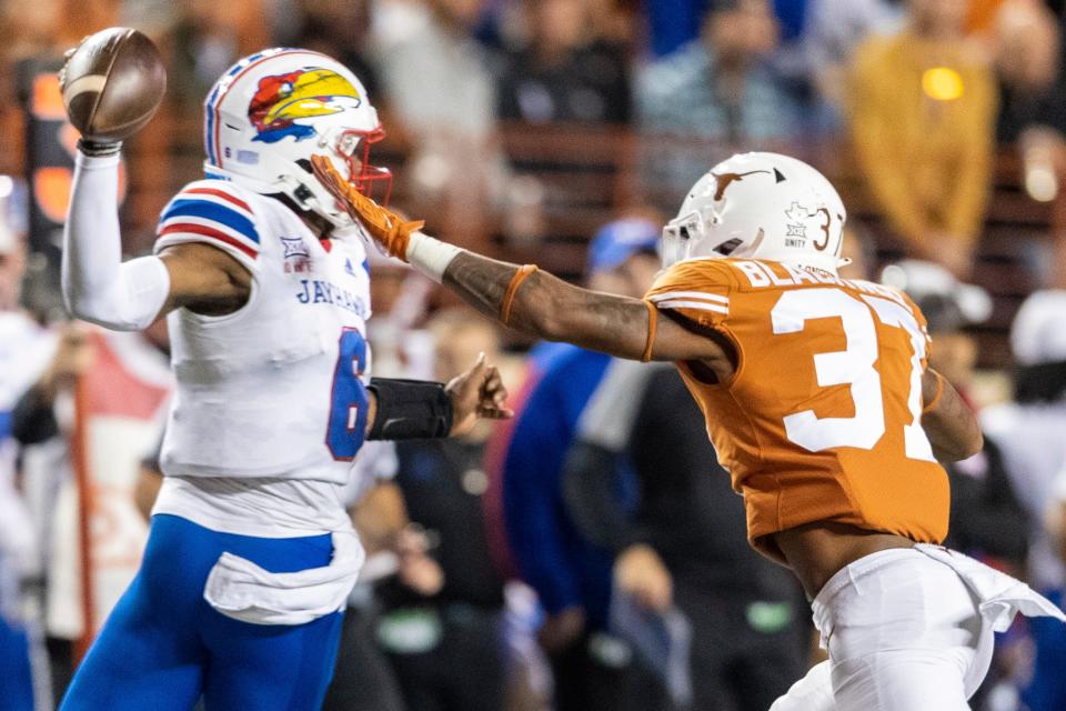 Texas linebacker Morice Blackwell Jr. pressures Kansas quarterback Jalon Daniels in the Jayhawks' 57-56 overtime win in Austin two years ago. The Big 12 rivals will face off again in Austin on Saturday.