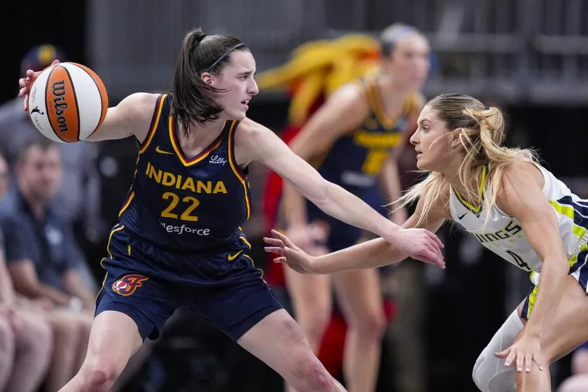 Dallas Wings guard Jacy Sheldon (4) defends Indiana Fever guard Caitlin Clark (22) i