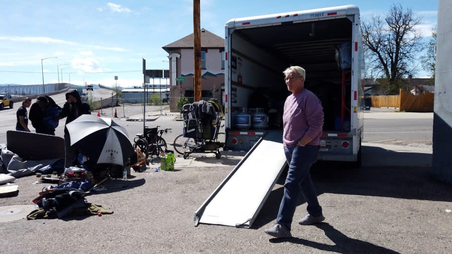 People pack their belongings in a moving truck