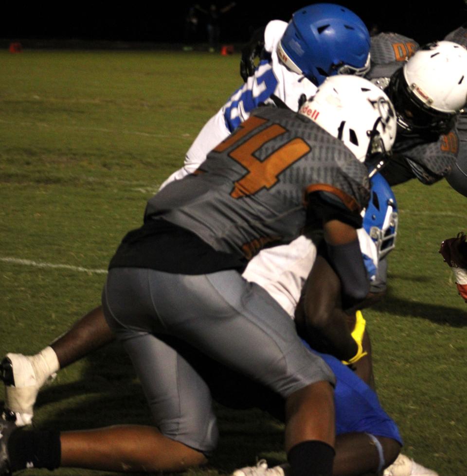 Atlantic Coast linebacker Camden Hardy (24) makes the tackle in a football game against Riverside.