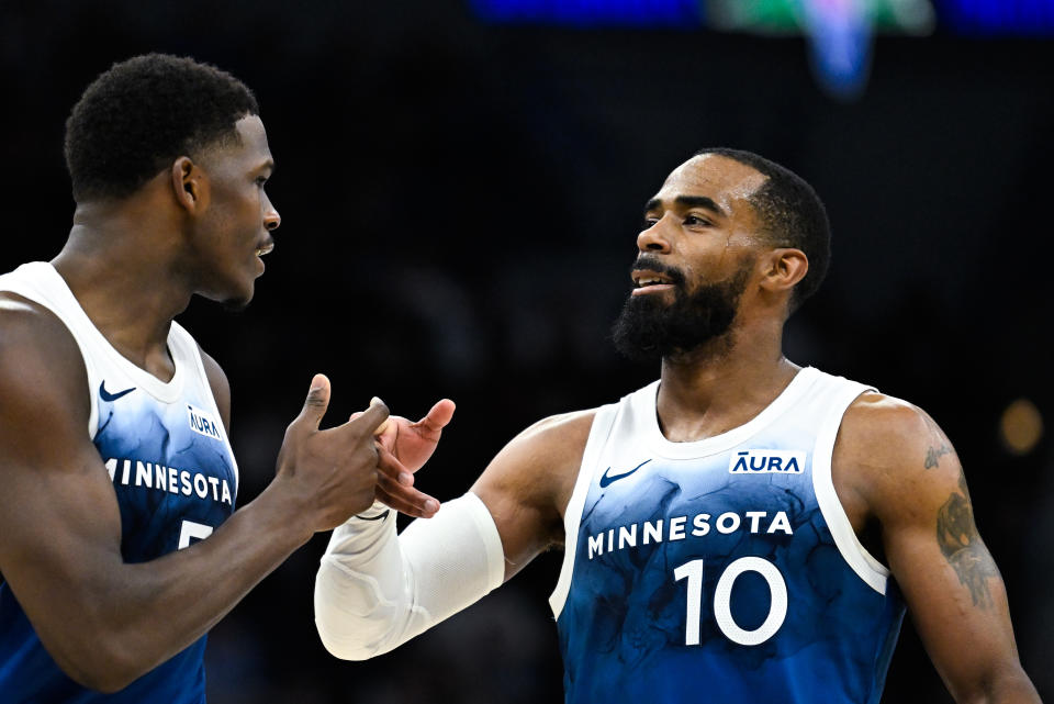 MINNEAPOLIS, MINNESOTA – APRIL 9: Anthony Edwards #5 celebrates with Mike Conley #10 of the Minnesota Timberwolves in the fourth quarter of the game against the Washington Wizards at Target Center on April 9, 2024 in Minneapolis, Minnesota.  NOTE TO USER: User expressly acknowledges and agrees that by downloading and/or using this photograph, User consents to the terms and conditions of the Getty Images License Agreement.  (Photo by Stephen Maturen/Getty Images)