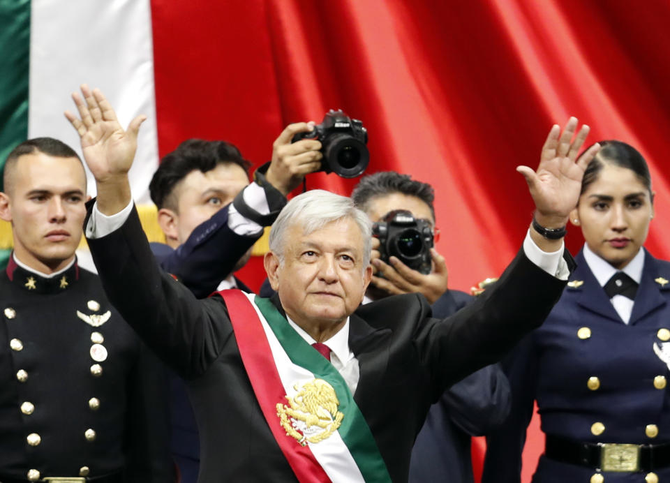 Mexico's new President Andres Manuel Lopez Obrador greets the crowd at the end of his inaugural ceremony at the National Congress in Mexico City, Saturday, Dec. 1, 2018. Mexicans are getting more than just a new president Saturday. The inauguration of Lopez Obrador will mark a turning point in one of the world's most radical experiments in opening markets and privatization. (AP Photo/Eduardo Verdugo)