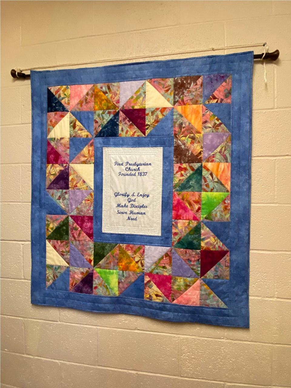 A wall-hanging outside explains First Presbyterian Church's mission.