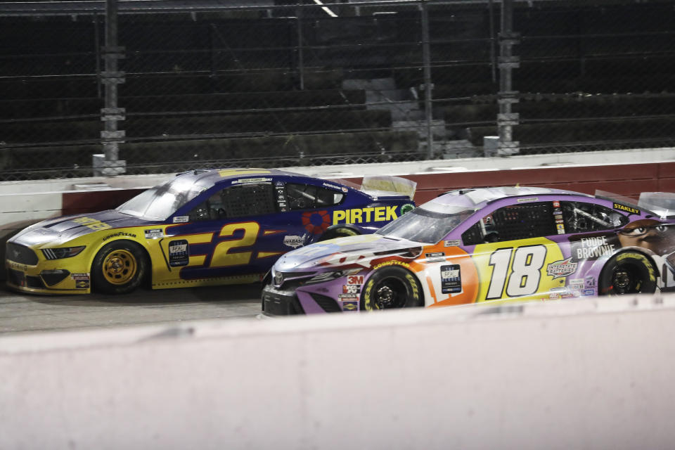 Brad Keselowski (2) and Kyle Busch (18) battle during the NASCAR Cup Series auto race Wednesday, May 20, 2020, in Darlington, S.C. (AP Photo/Brynn Anderson)