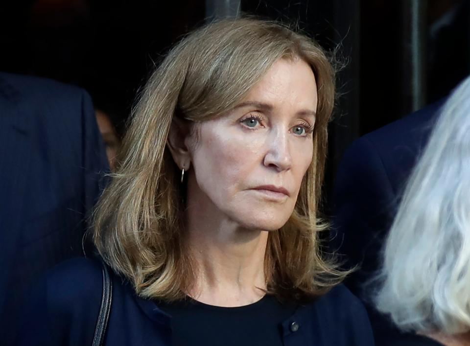 FILE - This Sept. 13, 2019 file photo shows actress Felicity Huffman leaving federal court after her sentencing in a nationwide college admissions bribery scandal in Boston.