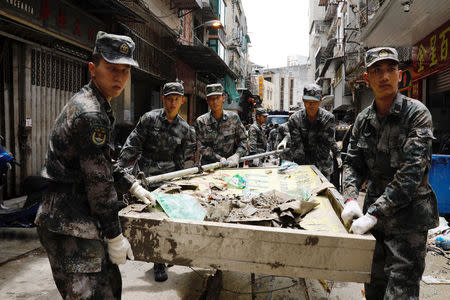 People’s Liberation Army (PLA) soldiers clean debris after Typhoon Hato hits in Macau, China August 25, 2017. REUTERS/Tyrone Siu