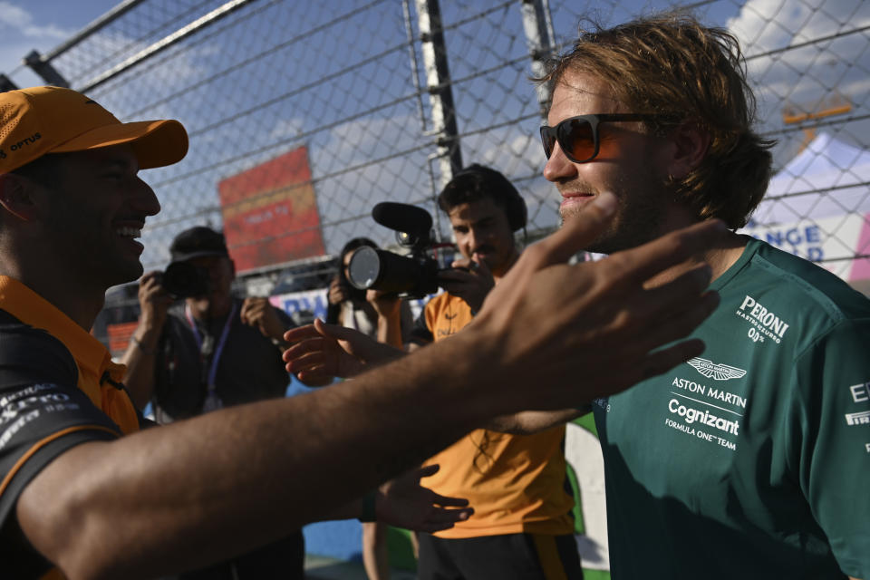 Aston Martin driver Sebastian Vettel of Germany, right, greets Mclaren driver Daniel Ricciardo of Australia at the Hungaroring racetrack in Mogyorod, near Budapest, Hungary, Thursday, July 28, 2022. The Hungarian Formula One Grand Prix will be held on Sunday. (AP Photo/Anna Szilagyi)