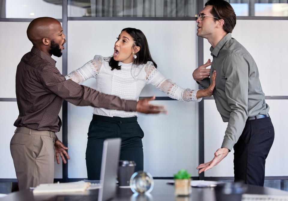 People arguing in an office conference room