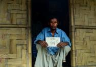 Jalal Ahmed with his old house number plate -- a faded piece of tin that provides a precious connection to his past