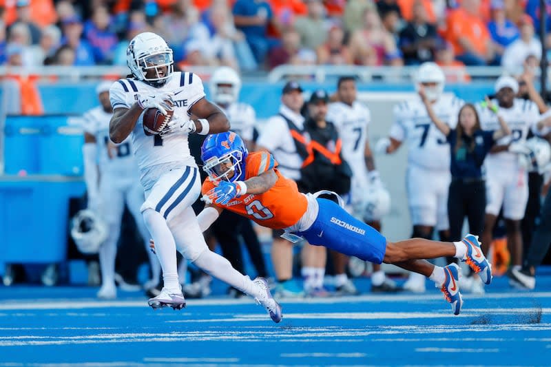 Utah State wide receiver Jalen Royals (1) runs through a diving tackle attempt by Boise State safety Ty Benefield (0) for a 59 yard touchdown reception in the first half of an NCAA college football game, Saturday, Oct. 5, 2024, in Boise, Idaho. . (AP Photo/Steve Conner) | Steve Conner