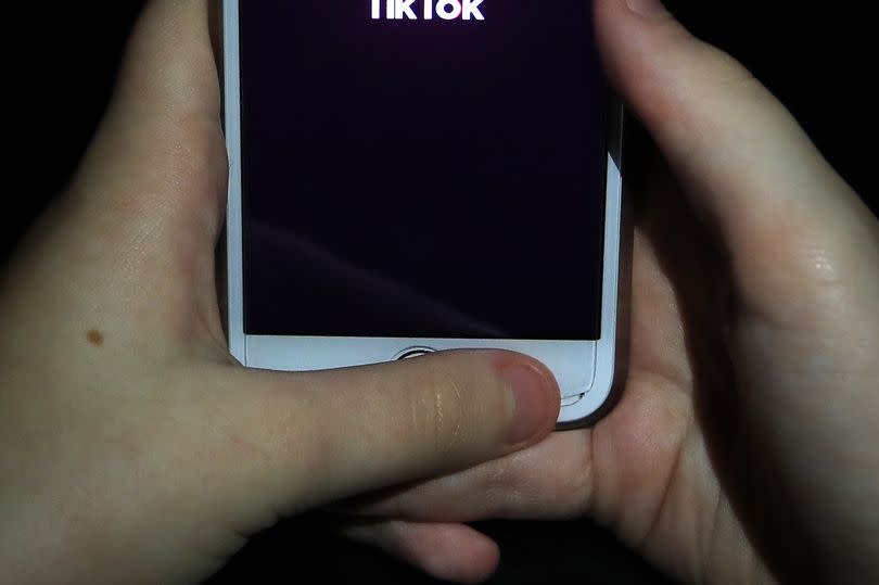 File photo dated 12/11/2019 of a young girl using the TikTok app on a smartphone. A third of 13 to 17-year-olds have seen footage of real-life violence on social media platform TikTok in the past year, research suggests. The poll of 7,500 teenagers for Home Office-backed charity the Youth Endowment Fund found a quarter had seen similar material on Snapchat, 20% on YouTube and 19% on Instagram. Issue date: Monday November 13, 2023.