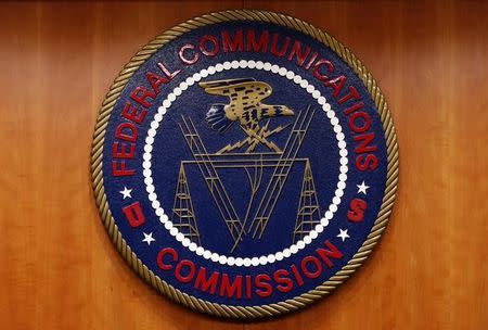 The Federal Communications Commission (FCC) logo is seen before the FCC Net Neutrality hearing in Washington February 26, 2015. REUTERS/Yuri Gripas