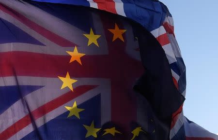 An EU flag and Union flag are seen flying together during an anti-Brexit protest near the Houses of Parliament in London, Britain, December 8, 2017. REUTERS/Toby Melville