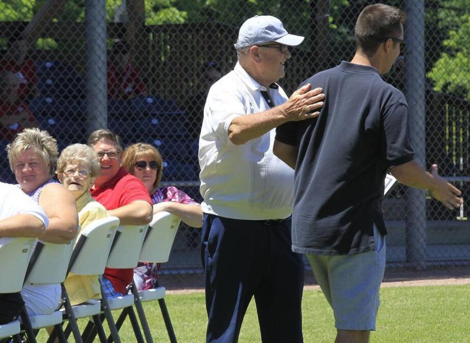 Former St. Louis Cardinals manager Whitey Herzog helped with the induction ceremony of players into the Belleville Hilgards Hall of Fame. Here, Herzog had just finished shaking hands with inductee Greg Steen (right).