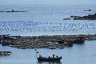 A boat moves through the water at the 68-nautical-mile scenic spot, the closest point in mainland China to the island of Taiwan, in Pingtan in southeastern China's Fujian Province, Friday, Aug. 5, 2022. China conducted "precision missile strikes" Thursday in waters off Taiwan's coasts as part of military exercises that have raised tensions in the region to their highest level in decades following a visit by U.S. House Speaker Nancy Pelosi. (AP Photo/Ng Han Guan)