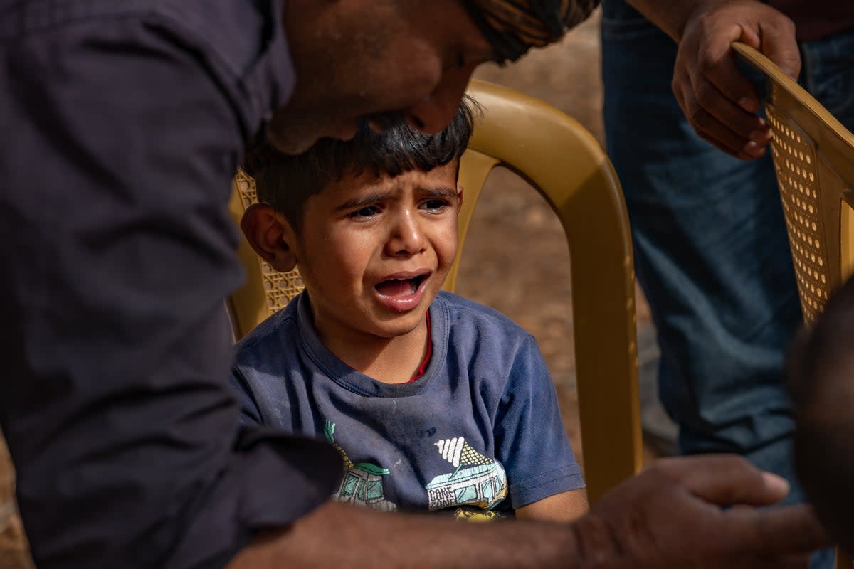 The six-year-old son of Ali Arrara, who has not stopped crying since the family were forced from their land at gunpoint (Bel Trew/The Independent)