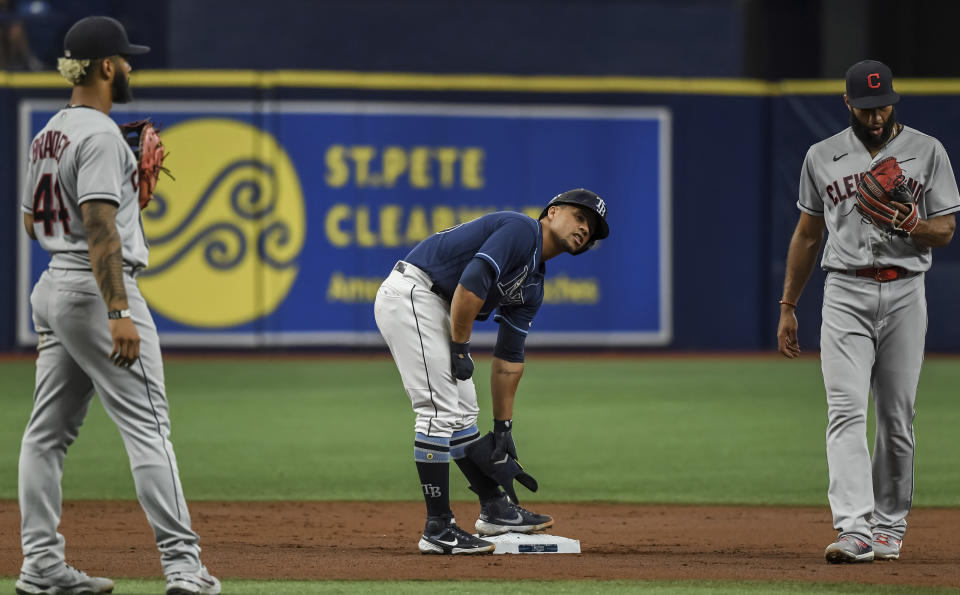 Tampa Bay Rays' Francisco Mejia stands on second between Cleveland Indians infielders Bobby Bradley, left, and Amed Rosario, right, after hitting a double during the second inning in the second baseball game of a doubleheader Wednesday, July 7, 2021, in St. Petersburg, Fla.(AP Photo/Steve Nesius)