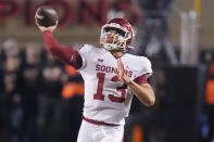 FILE - Oklahoma quarterback Caleb Williams throws during the first half of the team's NCAA college football game against Oklahoma State, Saturday, Nov. 27, 2021, in Stillwater, Okla. The former five-star prospect signed up to play with Lincoln Riley, who is now at Southern California. With the new NCAA transfer rules, the first question is: Does he stay?(AP Photo/Sue Ogrocki, File)