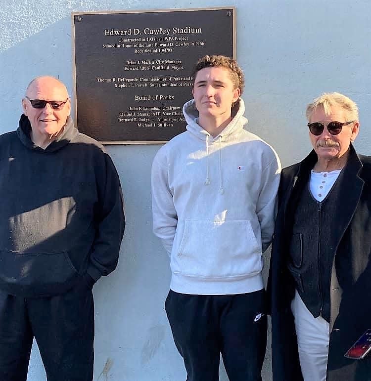 Winnacunnet High School senior football captain Jack Hogan stands with his uncles Stephen Begley, left, and Eddie Begley, outside Edward D. Cawley Memorial Stadium in Lowell, Massachusetts Thanksgiving morning. Winnacunnet beat Lowell, 8-7 in the inaugural Friendship Bowl. Edward Cawley is the great-great-grand uncle to Jack, and great uncle to Stephen and Eddie.