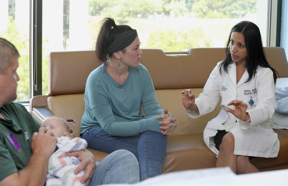 Akron Children's Hospital Nephrologist Dr. Shefali Mahesh (at right) speaks to Brad and Carlla Detwiler. (Karen Schiely)