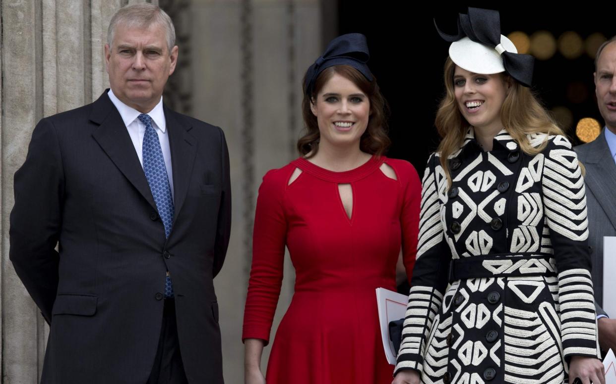 Prince Andrew with Beatrice and Eugenie - AFP