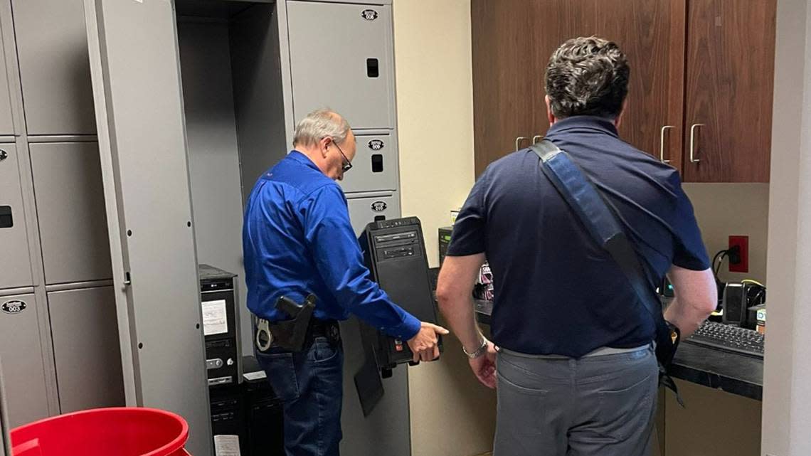 The Marion County Record’s computers were handed over to a forensic expert, right, hired by the paper’s attorney.