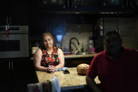 Rosalinda Ramirez, 57, and her partner Jose Guerrero, 41, Mexican immigrants who crossed the border separately over two decades ago and who have built lives and he a landscaping business in the U.S. but never found a route to obtain legal status, talk to AP journalists at their home in Homestead, Fla., Tuesday, Nov. 7, 2023. The couple are among those longterm immigrants in the U.S. who are frustrated to see newer arrivals getting work permits and government assistance, while they have paid taxes for decades without earning work permits, the ability to visit relatives back home and return, or freedom from the fear of deportation. (AP Photo/Rebecca Blackwell)