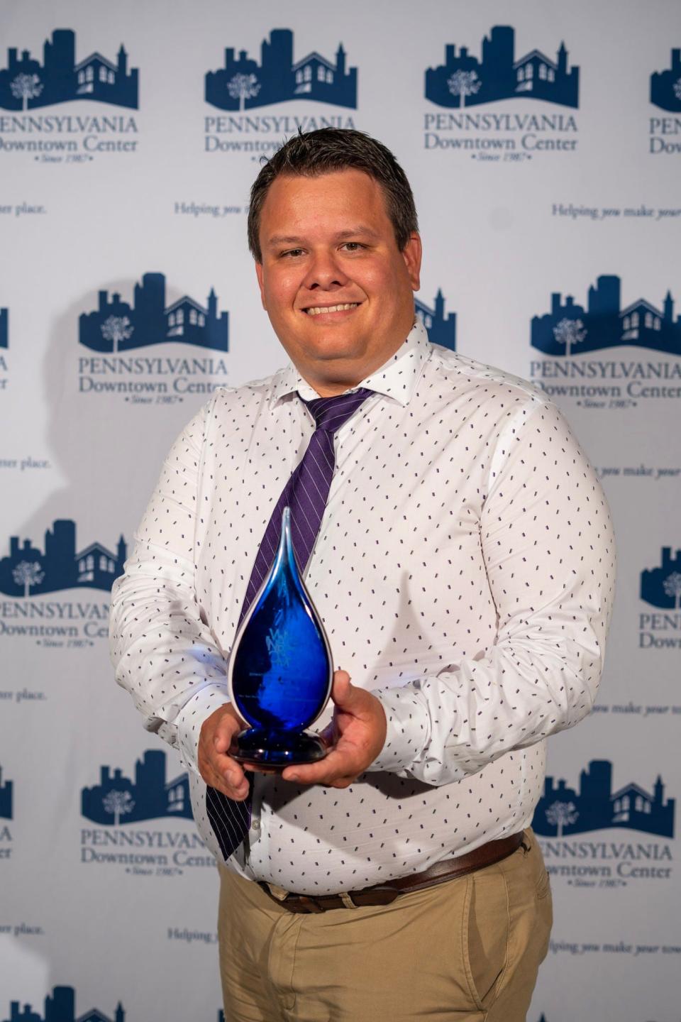 Sam Thrush, president of Downtown Chambersburg Inc., holds the Townie Award for Special Events that his organization won at the recent Pennsylvania Downtown Council's annual conference.