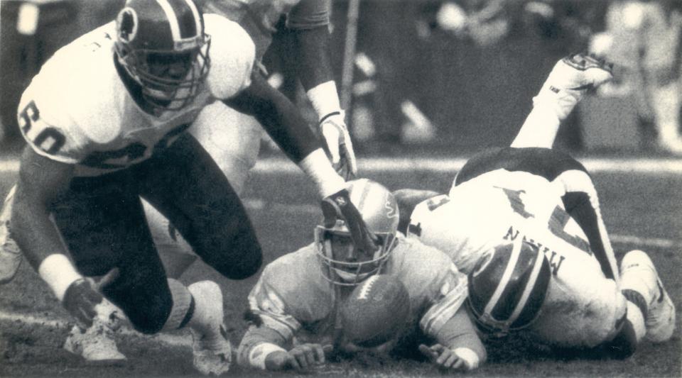 Sacked Lions QB Erik Kramer watches a fumble recovery by Washington in a 41-10 loss in the NFC championship game on Jan. 12, 1992.