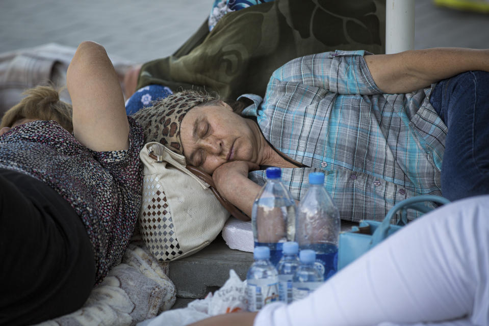 Supporters of the former government sleep outside the prosecutors office in Chisinau, Moldova, Wednesday, June 12, 2019. Moldova's police chief on Wednesday dismissed six officers who publicly backed a rival government, reflecting a continuing power struggle that has heightened political tensions in the impoverished ex-Soviet nation.(AP Photo/Roveliu Buga)