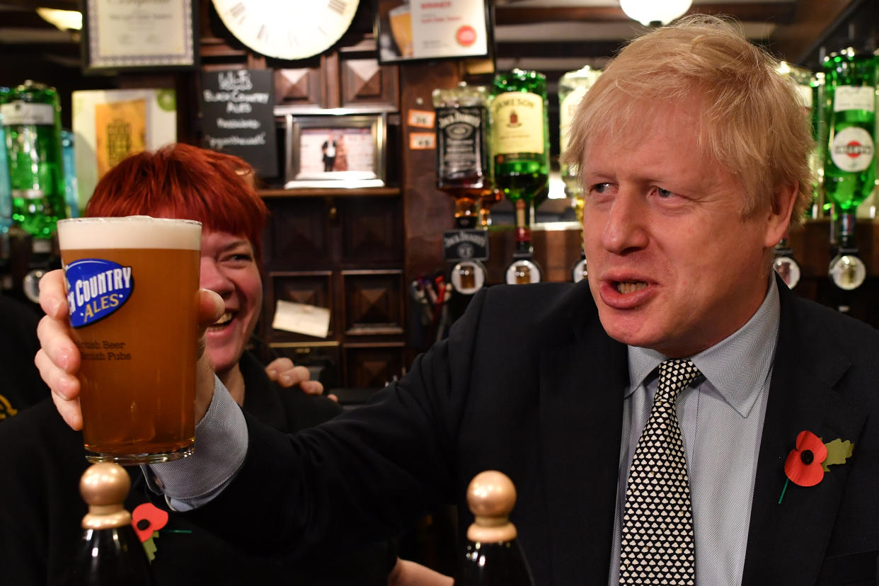 WOLVERHAMPTON, UNITED KINGDOM - NOVEMBER 11: British Prime Minister Boris Johnson raises a pint of beer as he campaigns ahead of the general election at the Lynch Gate Tavern on November 11, 2019 in Wolverhampton, United Kingdom. The U.K. will go to the polls in a general election on December 12. (Photo by Ben Stansall – WPA Pool/Getty Images)