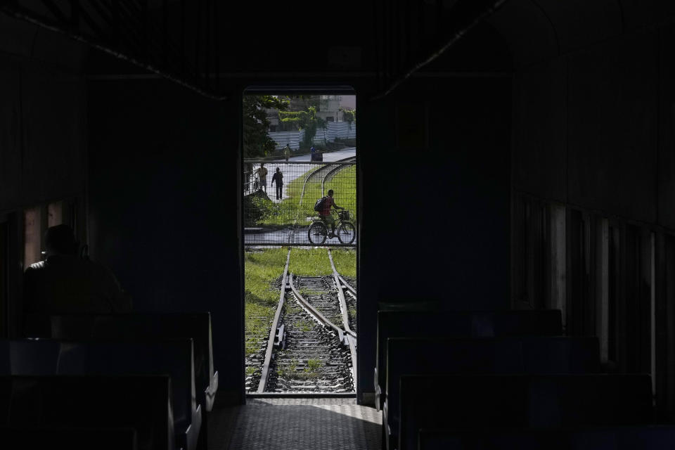 Seen from inside a railroad car, a gate blocks the railroad into the Bebedouro neighborhood of Maceio, Alagoas state, Brazil, Monday, March 7, 2022. Bebedouro is one of the neighborhoods that in the course of three years, residents have been forced to abandon because of geological problems arising from mining activities that have created the threat of ground subsidence. (AP Photo/Eraldo Peres)