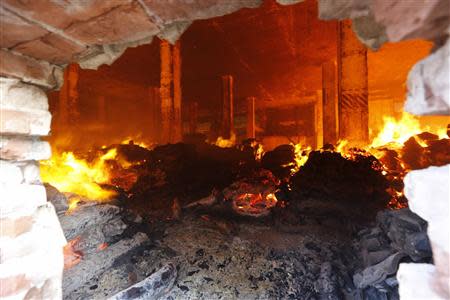 A fire burns inside the warehouse of a Standard Group garment factory in Gazipur November 29, 2013. There were no reports of casualties in the fire. REUTERS/Andrew Biraj