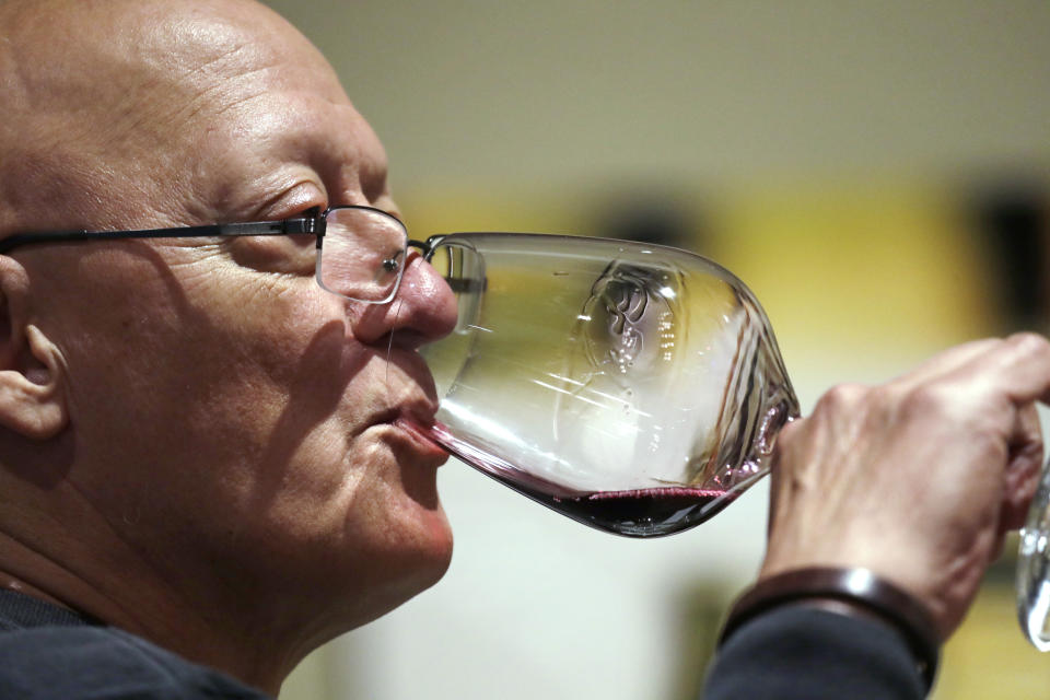 In this photo taken Thursday, Nov. 21, 2019, Ben Norton sips a red wine during a tasting at Chateau Ste. Michelle winery in Woodinville, Wash. Washington, which now boasts more than 1,000 wineries in the state, has become a force in the wine industry. The state is the second-largest producer of premium wines in the United States, trailing only California. (AP Photo/Elaine Thompson)