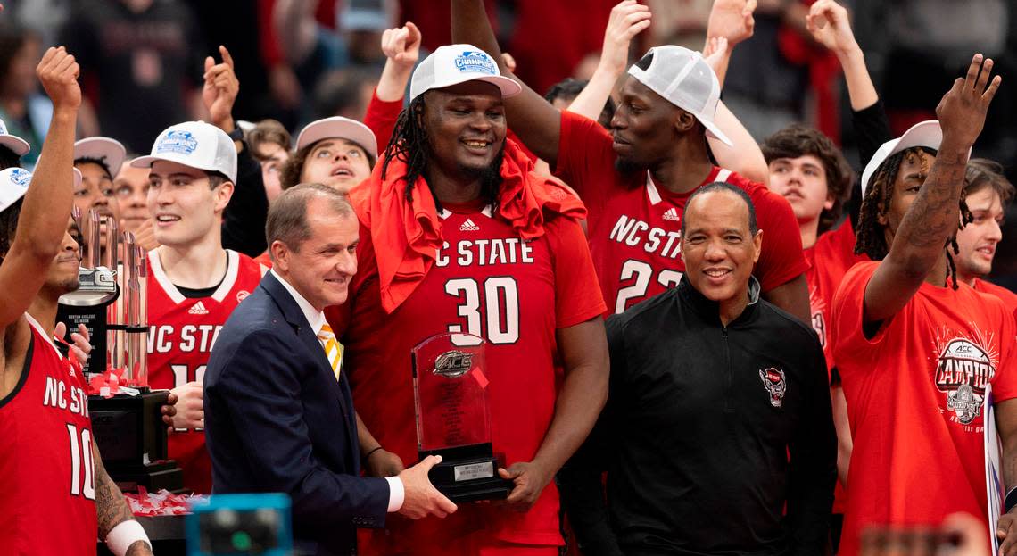 ACC Commissioner Jim Phillips presents the tournament MVP trophy to N.C. State’s D.J. Burns Jr. (30) following the Wolfpack’s ACC Tournament victory over North Carolina at Capitol One Arena on Saturday, March 16, 2024 in Washington, D.C.