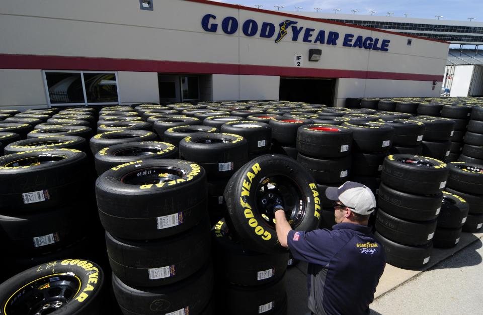 Brayden Wienke stacks tires at Texas Motor Speedway in Fort Worth, Texas, Friday, April 4, 2014. NASCAR will not regulate tire pressures at the speedway, and if drivers have tire failures during Sunday's race officials believe they will not be able to blame Goodyear. (AP Photo/Ralph Lauer)