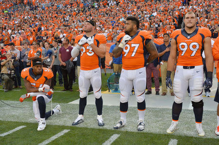 Sep 8, 2016; Denver, CO, USA; Denver Broncos inside linebacker Brandon Marshall (54) kneels during the national anthem next to defensive end Jared Crick (93) and defensive tackle Billy Winn (97) and defensive tackle Adam Gotsis (99) before the game against the Carolina Panthers at Sports Authority Field at Mile High. Ron Chenoy-USA TODAY Sports