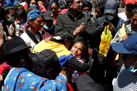 Indigenous people embrace in the aftermath of the last days' protests in Quito