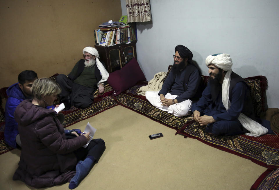 In this Saturday, Dec. 14, 2019, photo, Maulvi Niaz Mohammad, 45, second right, speaks during an interview with The Associated Press inside the Pul-e-Charkhi jail in Kabul, Afghanistan. Thousands of Taliban prisoners jailed as insurgents see a peace deal being hammered out in Qatar as their ticket to freedom. Prisoner release is a key pillar of any agreement the U.S. strikes with the Taliban to end Afghanistan’s 18-year war. (AP Photo/Rahmat Gul)