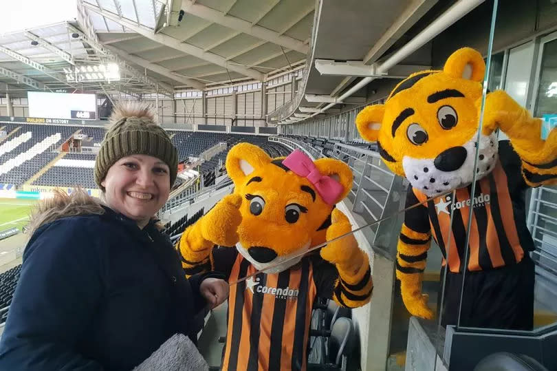 Julia with Hull City mascots Amber and Roary at the MKM Stadium
