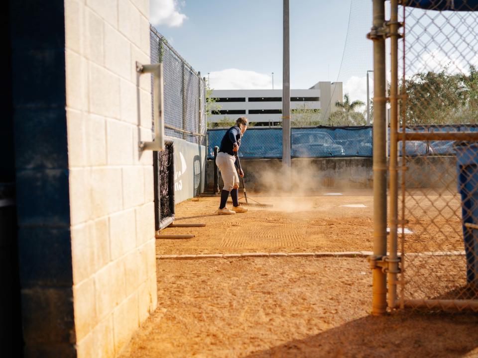 Hutzler completes chores after practice. (Martina Tuaty for The Washington Post)