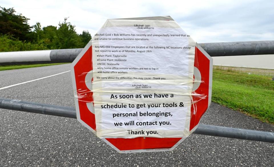 Hundreds of furniture company workers lost their jobs after the Mitchell Gold + Bob Williams furniture company closed abruptly in August. A sign posted on the gate at Taylorsville, N.C., plant says not to report to work on Monday, Aug. 28.