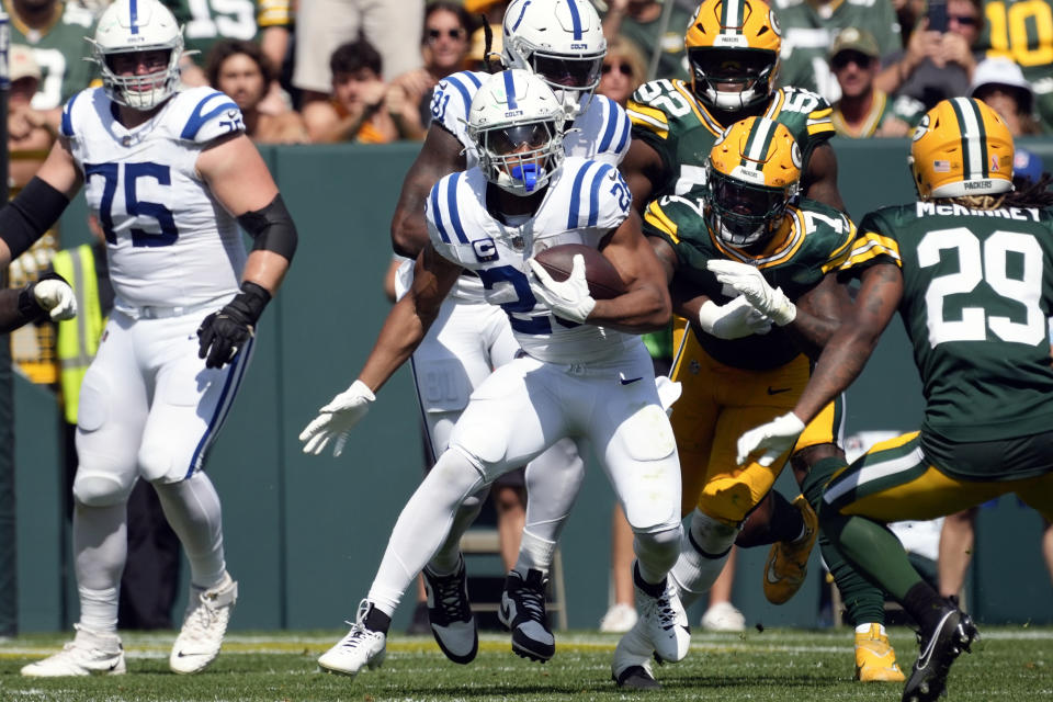 Indianapolis Colts running back Jonathan Taylor (28) runs past Green Bay Packers linebacker Quay Walker (7) for a first down during the first half of an NFL football game Sunday, Sept. 15, 2024, in Green Bay, Wis. (AP Photo/Morry Gash)