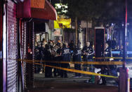 New York City police officers gather early Thursday, June 4, 2020, near the site of shooting Wednesday night in the Brooklyn borough of New York. The police department says an officer has been shot in Brooklyn. The shooting happened late Wednesday, nearly four hours after an 8 p.m. curfew went into effect intended to quell unrest over the death of George Floyd in Minnesota. Details on the shooting, including the officer's condition, weren’t immediately available. (AP Photo/Frank Franklin II)