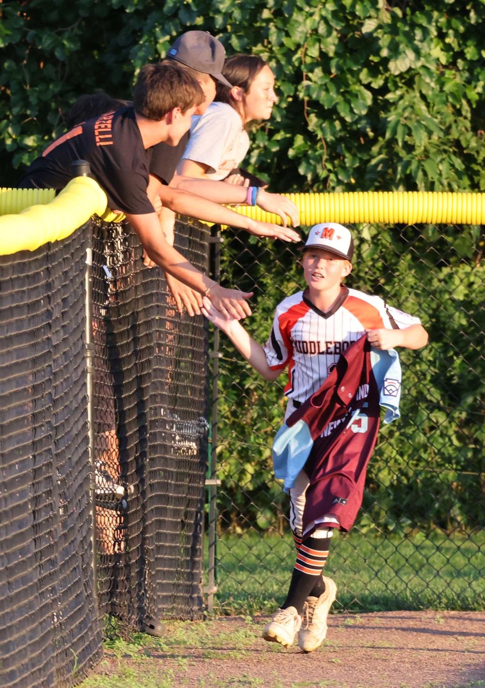 Middleboro 12U Nationals Reece Trottier carries the New England jersey around the field at the conclusion of their game versus Bangor East, Maine at Bartlett Giamatti Little League Leadership Training Center in Bristol, Connecticut for the New England Regional tournament on Thursday, August 11, 2022.