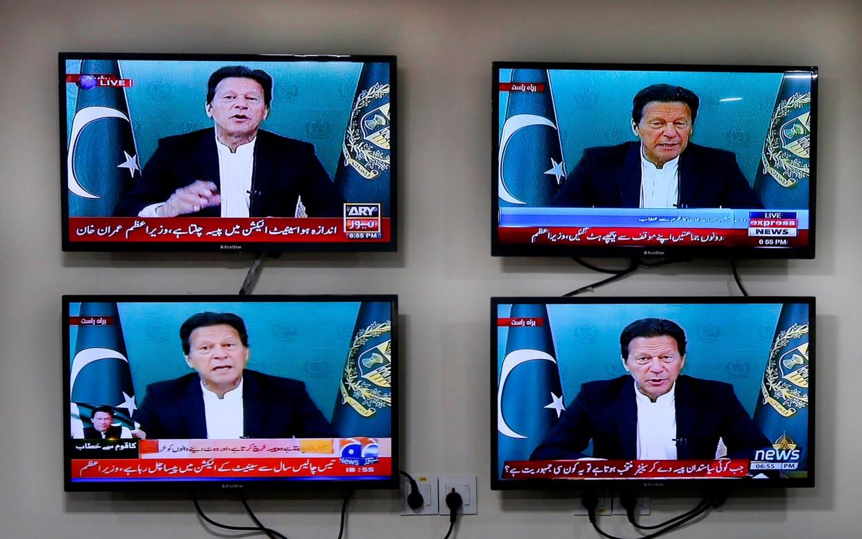 Various Pakistani news channels broadcast a live address to the nation by Pakistan's Prime Minister Imran Khan, at the office of The Associated Press, in Islamabad, Pakistan Thursday, March 4, 2021. Khan on Thursday announced he would seek a vote of confidence from the National Assembly this weekend to prove he still has the support of majority lawmakers in the house, despite the surprising and embarrassing defeat of his ruling party's key candidate in Senate's elections.