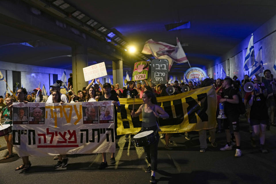 People take part in a protest against Israeli Prime Minister Benjamin Netanyahu's government, demanding new elections and the release of the hostages held in the Gaza Strip by the Hamas militant group, in Jerusalem, Monday, June 17, 2024. (AP Photo/Ohad Zwigenberg)