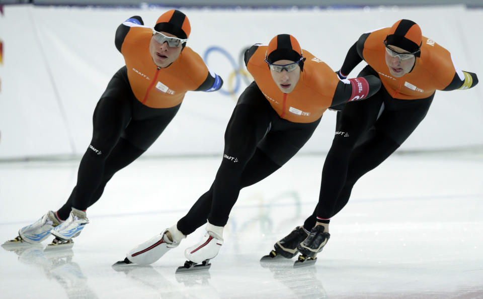 Speedskaters from team Netherlands, from left to right, Koen Verweij, Jan Blokhuijsen, and Sven Kramer compete in the men's speedskating team pursuit quarterfinals at the Adler Arena Skating Center during the 2014 Winter Olympics in Sochi, Russia, Friday, Feb. 21, 2014. (AP Photo/Matt Dunham)